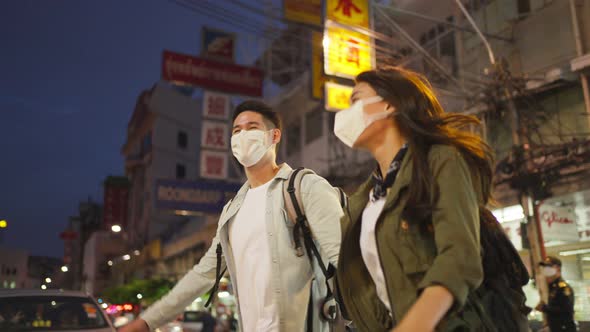 Asian attractive couple travel in the city for honeymoon trip at night. alt