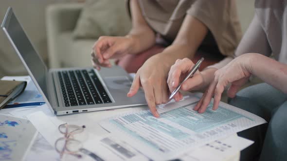 Women Doing Tax Returns Together alt