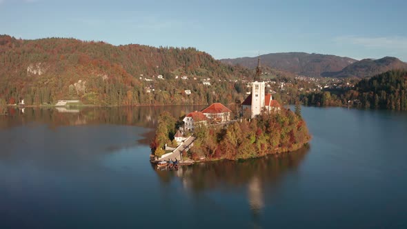 Amazing Aerial View of the Colorful Forest and Lake Bled with a Small Island with a Church. Sunrise