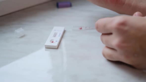A woman doing a rapid test at home to determine the coronavirus, COVID 19