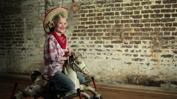 Young girl rocking on rocking horse alt