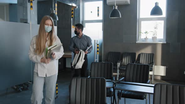 Young Diverse Group Students Classmates in Medical Masks Come Into Classroom Sit Down at Desks alt