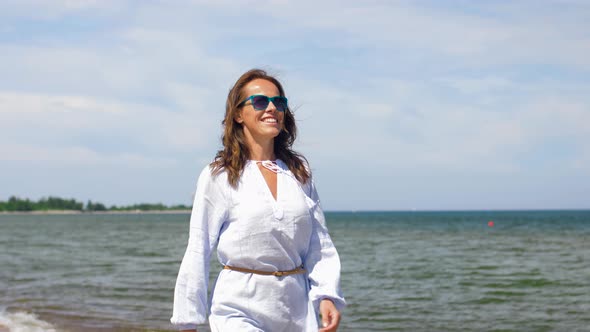 Happy Smiling Woman Walking Along Summer Beach alt