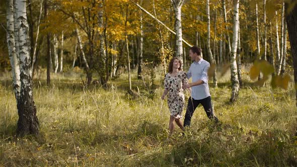 Young Couple Walking on a Meadow alt