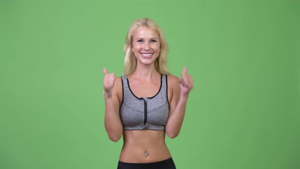Young Happy Beautiful Woman Giving Thumbs Up and Looking Excited Ready for Gym