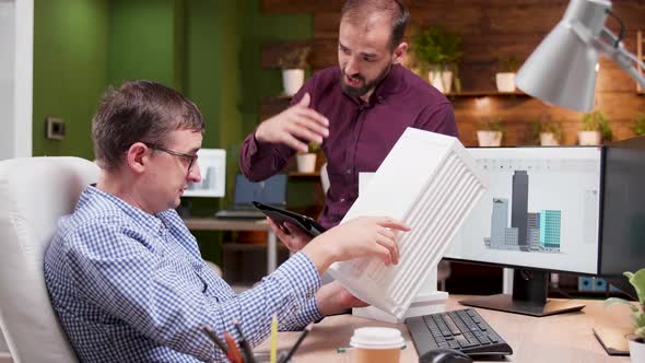 Architect in the Office Talking About the Engineering for the New Building Structure alt