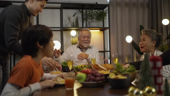 Asian family having dinner at dining table at home