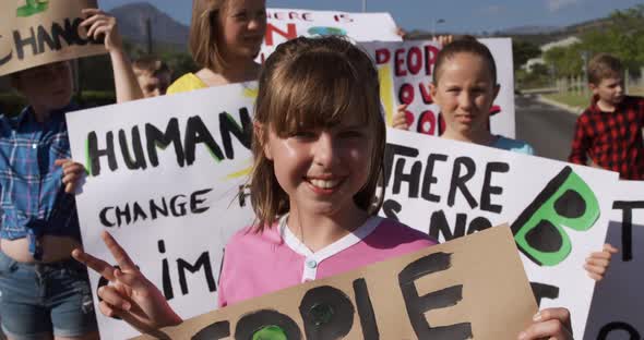 Girl with climate change sign in a protest alt