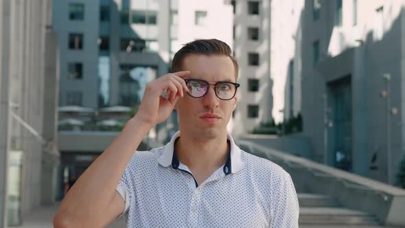 Portrait of Shocked Young Businessman Takes Off His Glasses in Surprise. Astonished Man Scared By alt