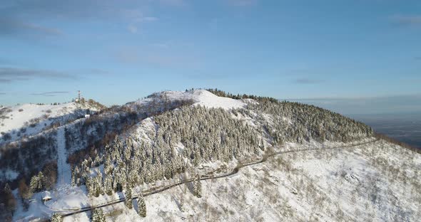 Forward Aerial Top View on White Snow Mountain Valley in Winter