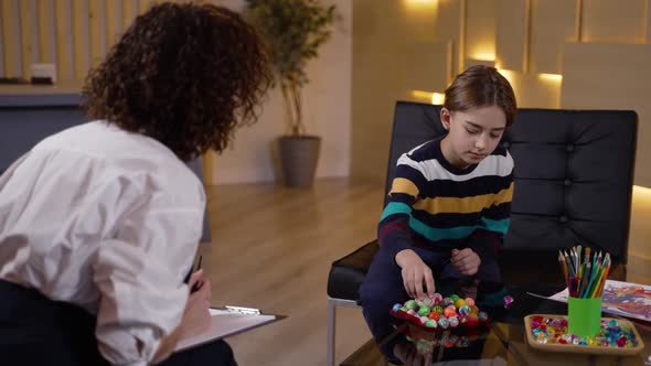 Therapist Using Colored Balls to Test Kid Patient alt