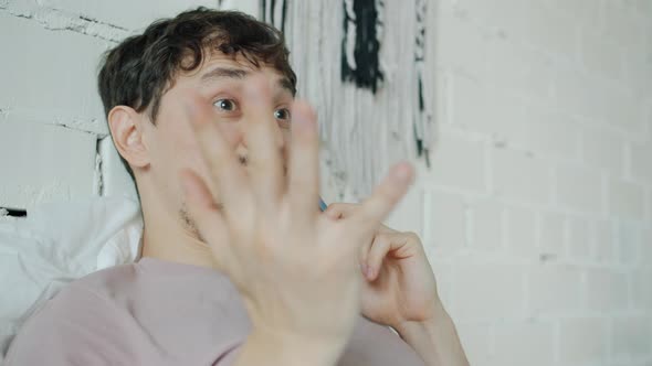 Portrait of Happy Student Talking on Mobile Phone and Smiling in Bedroom at Home alt