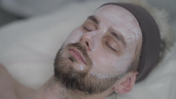 Closeup Male Face with Closed Eyes with White Purifying Cleansing Facial Cream alt