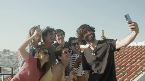 Cheerful Caucasian Friends Taking Selfie at Rooftop Party