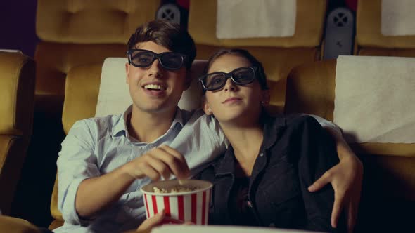 Man and Woman in the Cinema Watching a 3D Movie alt