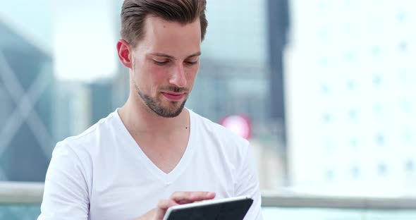Young man looking at tablet computer alt