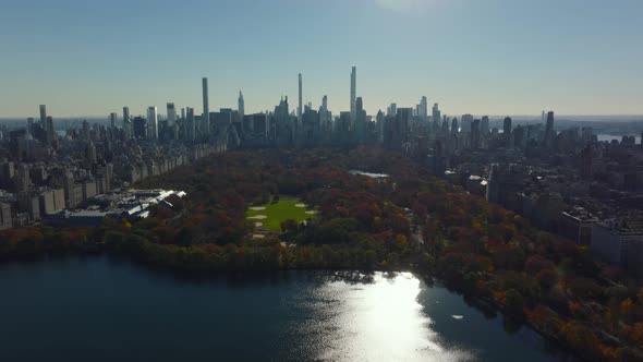 Aerial Descending Footage of Water Reservoir Softball Fields and Autumn Trees in Central Park alt