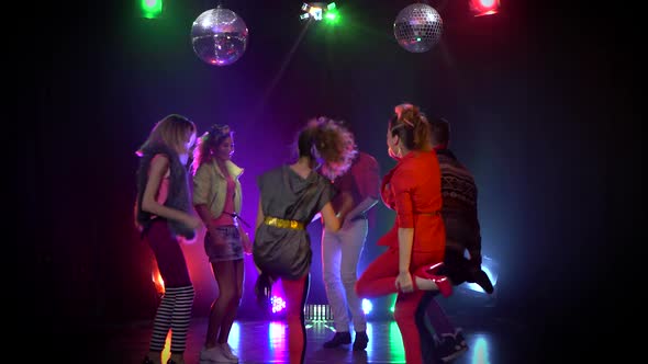 People Joyful and Dancing at a Nightclub Glowing Strobe Lights alt