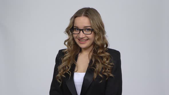 Cute Girl Is Showing Heart with Fingers and Blowing Kiss alt