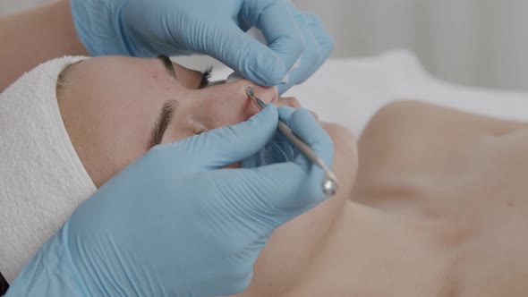 Beautician Cleaning Face