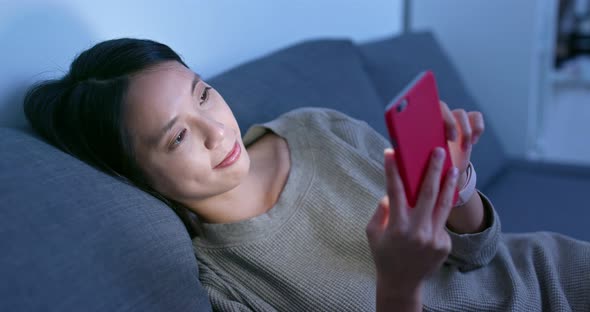 Woman use of smart phone at night alt