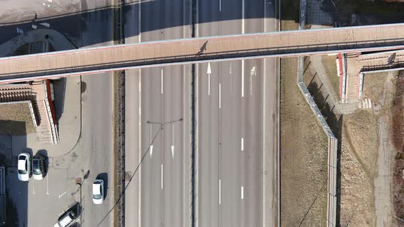 Top Down Aerial View of Highway Traffic and Pedestrian Bridge Overpass on Sunny Autumn Day, High Ang alt