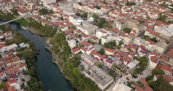 Wide angle panoramic pan of Old town Mostar and Neretva River, filmed from the air alt