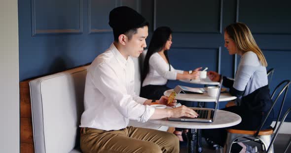 Asian Businessman using laptop in cafeteria at office 4k