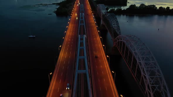 Top View of Lightened City Road Bridge Above the River alt