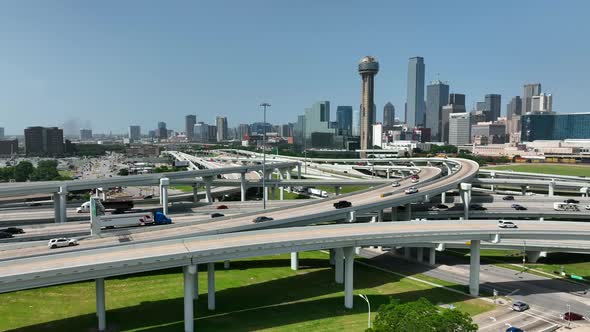 Dallas Texas skyline with traffic on interstate loop around downtown city. Aerial shot with blue sky alt