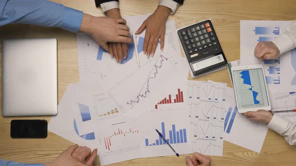 Top View of a Young Business Team Shaking Hands Rejoicing in a Good Deal alt