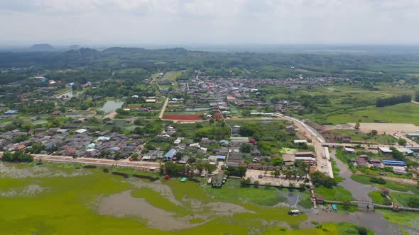 Aerial view of roofs of local village houses. Residential buildings in Nakhon Si Thammarat, alt