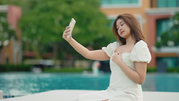 Asian cute girl She used her cell phone to walk around taking pictures of selfie having fun.