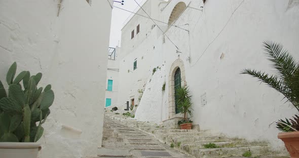 narrow street with white houses in the European old town, steps alt