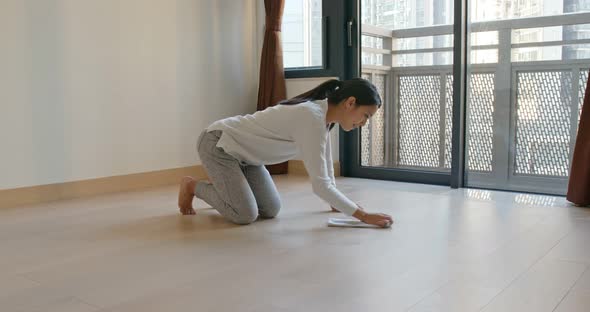 Woman clean the floor at home alt