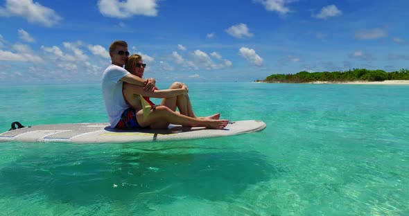 Young couple on honeymoon vacation enjoy life on beach on paradise white sand background  alt