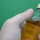 Man holds and twirls a bottle of strong alcohol in his hand - VideoHive Item for Sale