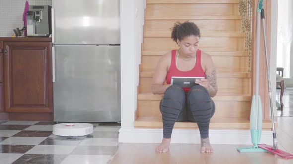 Portrait Adorable African American Woman Sitting on the Stairs on the First Floor of Big House alt