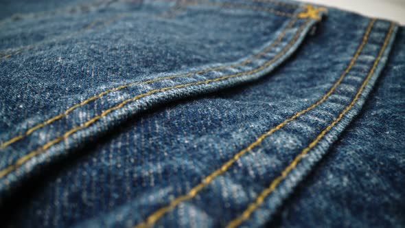 Extreme Detailed of Blue Denim Jeans Texture in Dolly Shot Over Cloth Surface alt