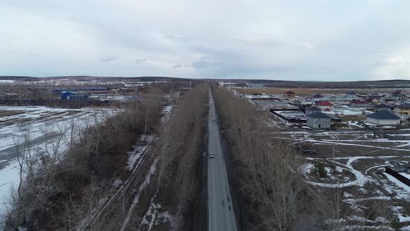Aerial view of a cars drives along a road near the cottage village 05 alt