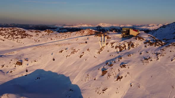 Snowy Mountain Skilifts and Furniculars and Skislopes in Austrian Alps Drone Flyover the Mountains