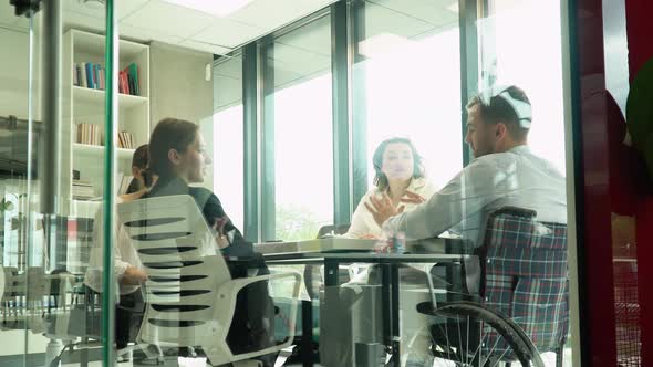 Group of Confident Coworkers Collaborating on a Project in a Morning Meeting alt