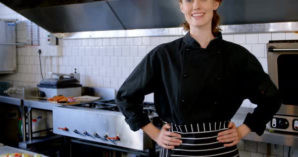 Chef standing with hands on hip in restaurant 4k alt