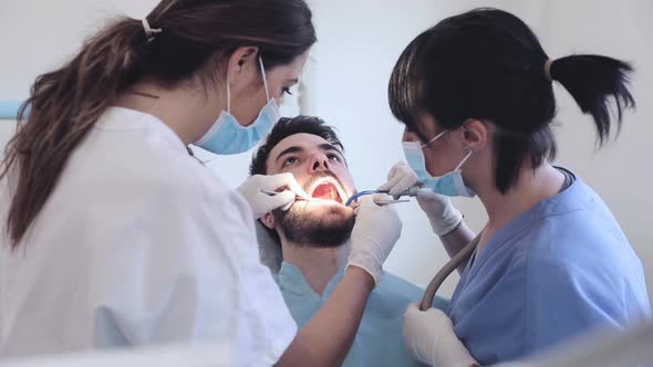 Patient getting dental treatment at dentist's surgery