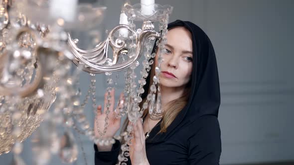 Romantic and Mysterious Mood of Young Woman Dressed Black Gown with Hood Portrait alt