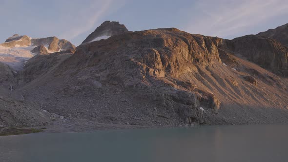 Panoramic View of Vibrant Colorful Glacier Lake Up in Rocky Mountains alt