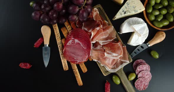 The Fragrant Antipasto Slowly Rotates on the Cutting Board.  alt