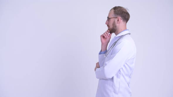 Profile View of Happy Bearded Man Doctor Thinking