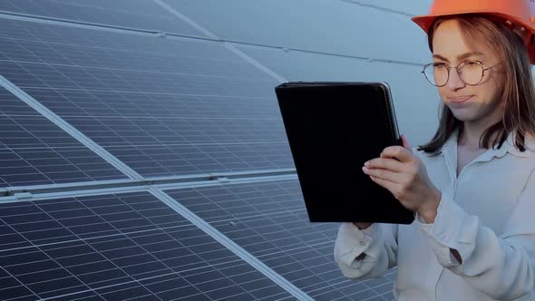 Inspector Engineer Woman Holding Digital Tablet Working in Solar Panels Power Farm alt