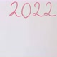 Hand writing the words &quot;2022 What awaits?&quot; on white blackboard - VideoHive Item for Sale